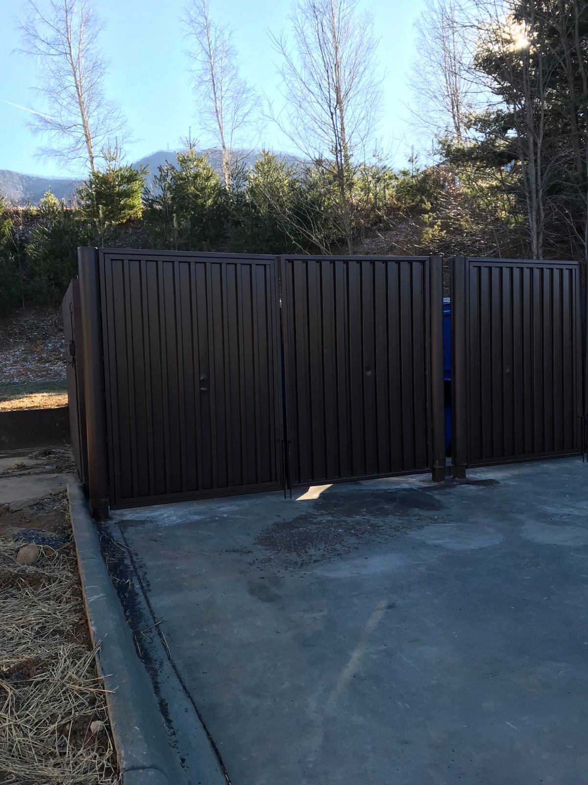 Brown steel dumpster enclosure gates at Bojangles in Jefferson NC