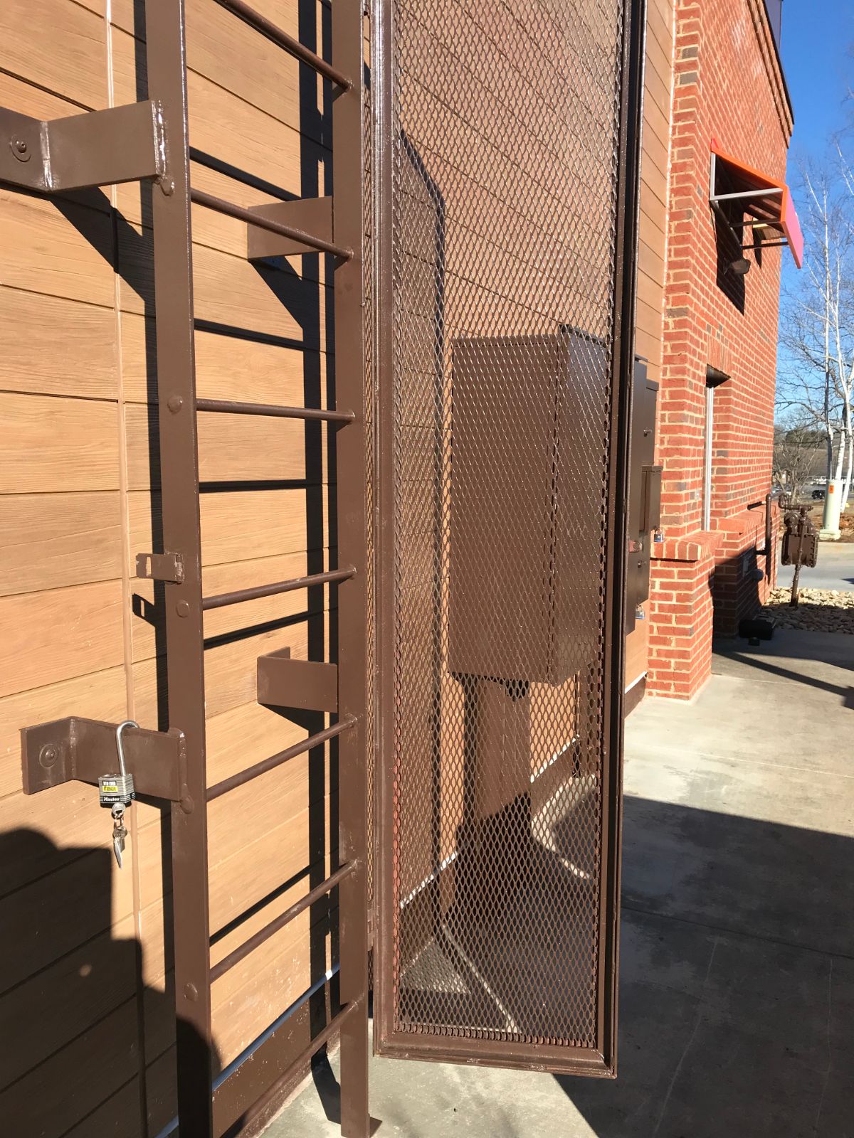 Roof ladder with locking expanded-metal cage barrier at Bojangles Jefferson NC