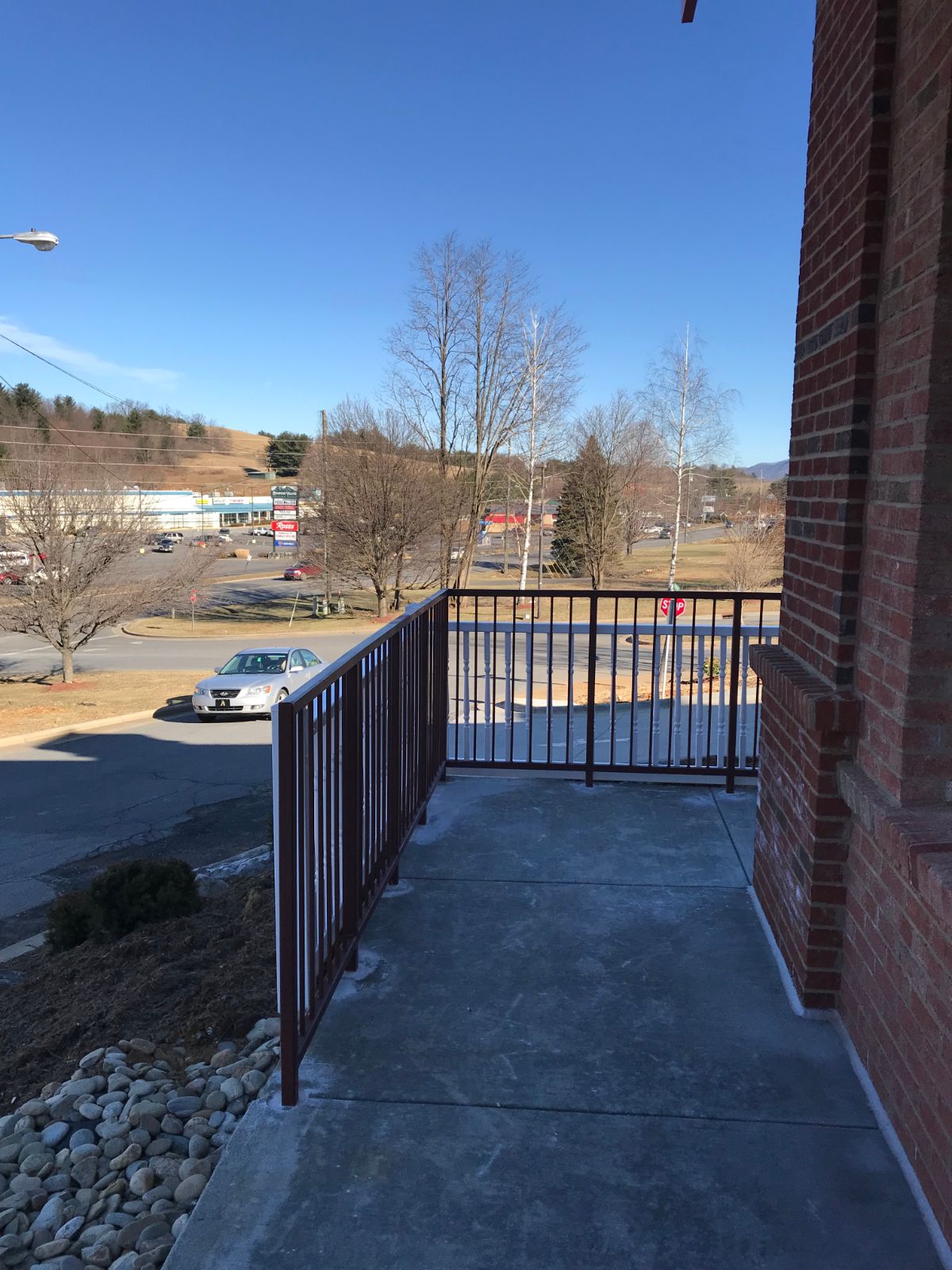 Steel safety railing along hillside sidewalk at Bojangles Jefferson NC