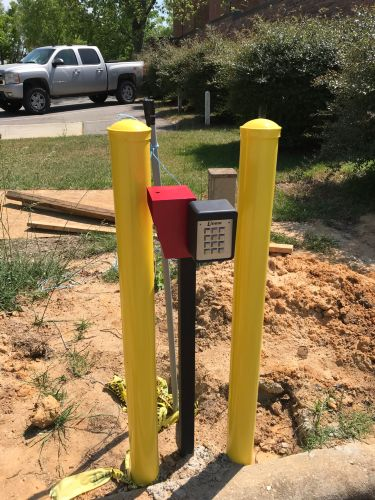 Yellow safety bollards with keypad access control at Chesterfield Judicial System