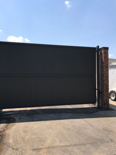 Wide dark steel perimeter slide gate at Chesterfield Judicial System