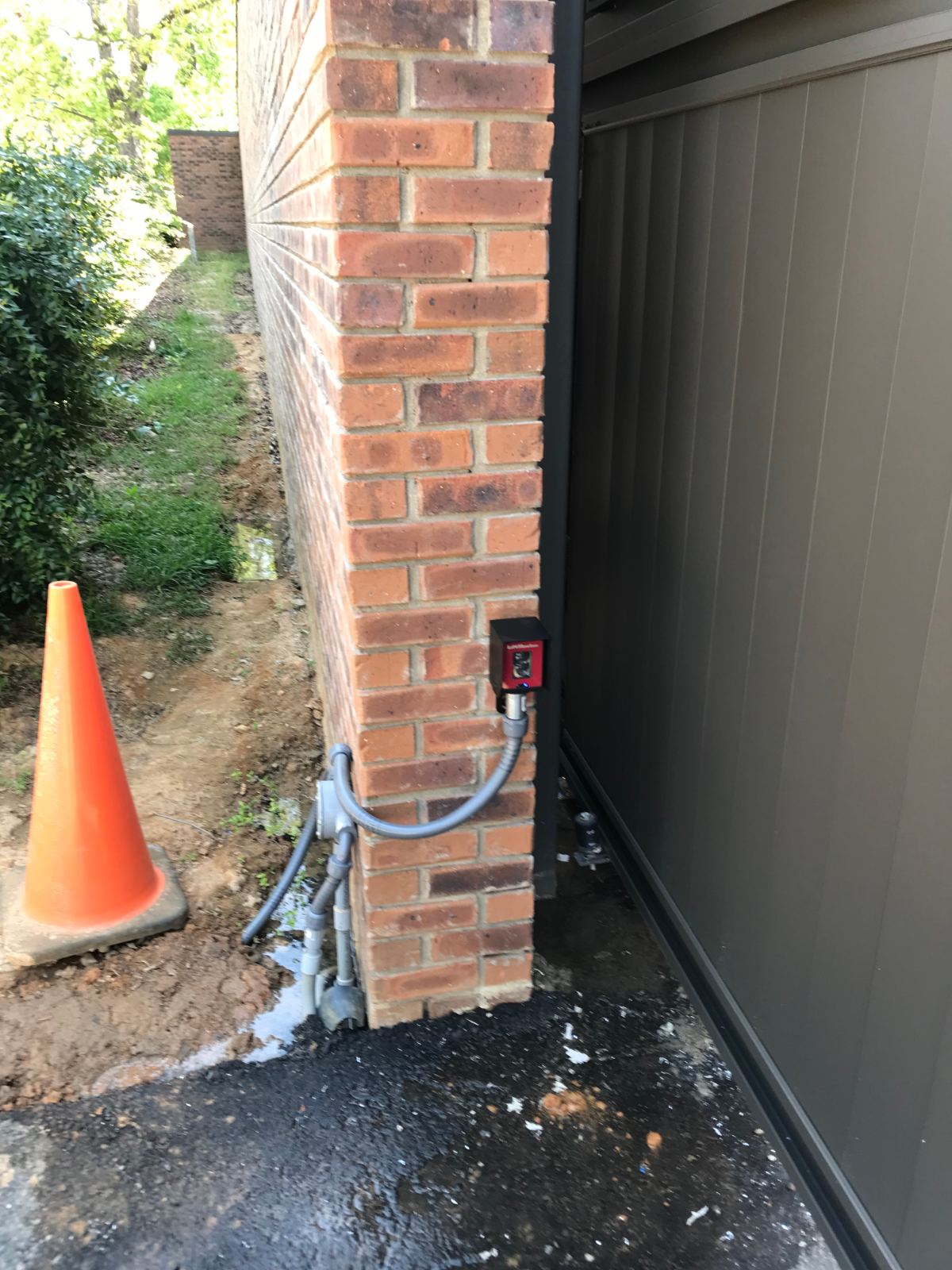 Outside photo-eye safety sensor mounted next to security gate