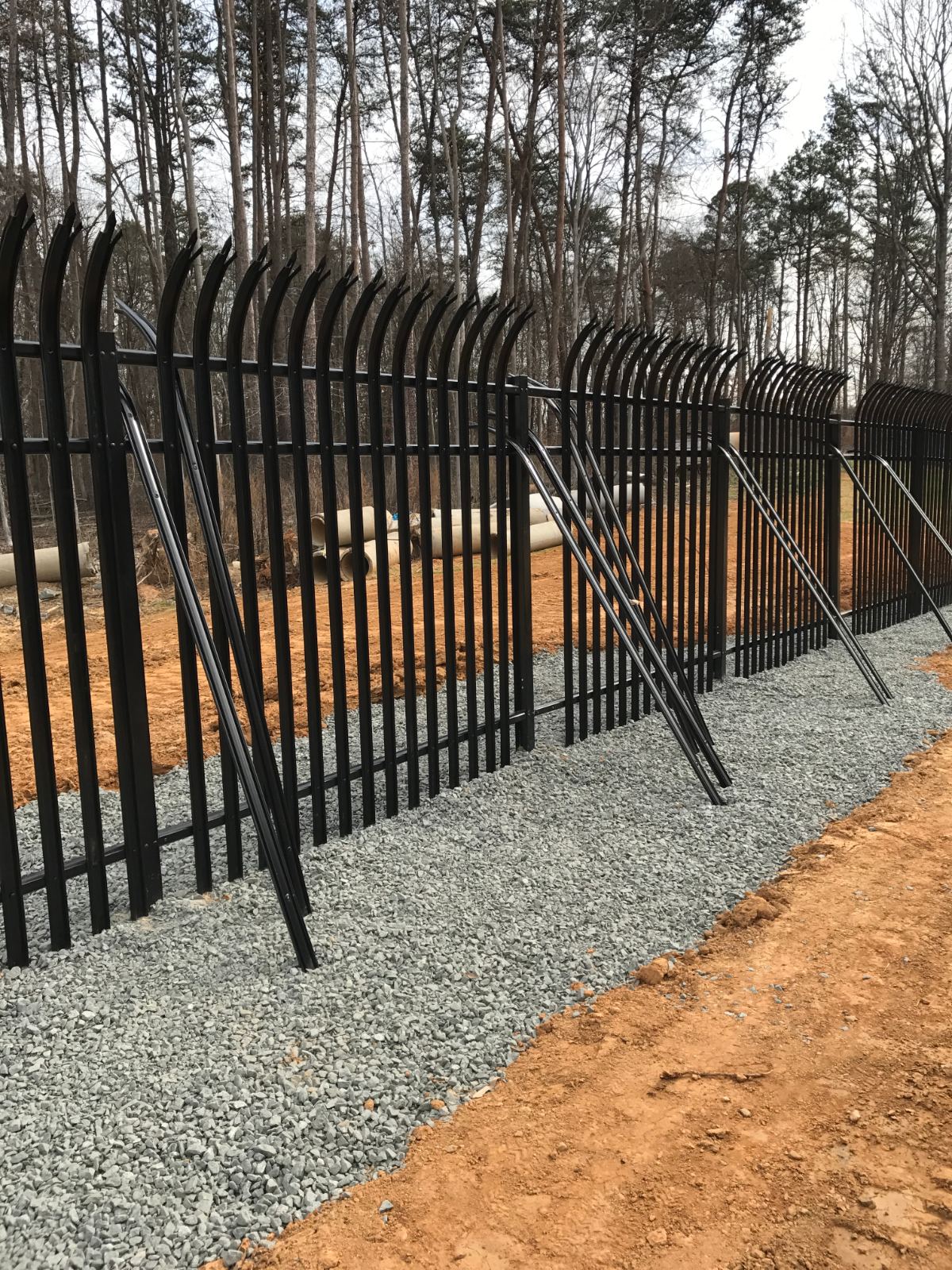 Ornamental steel palisade security fence detail with pointed pickets at Duke Energy facility