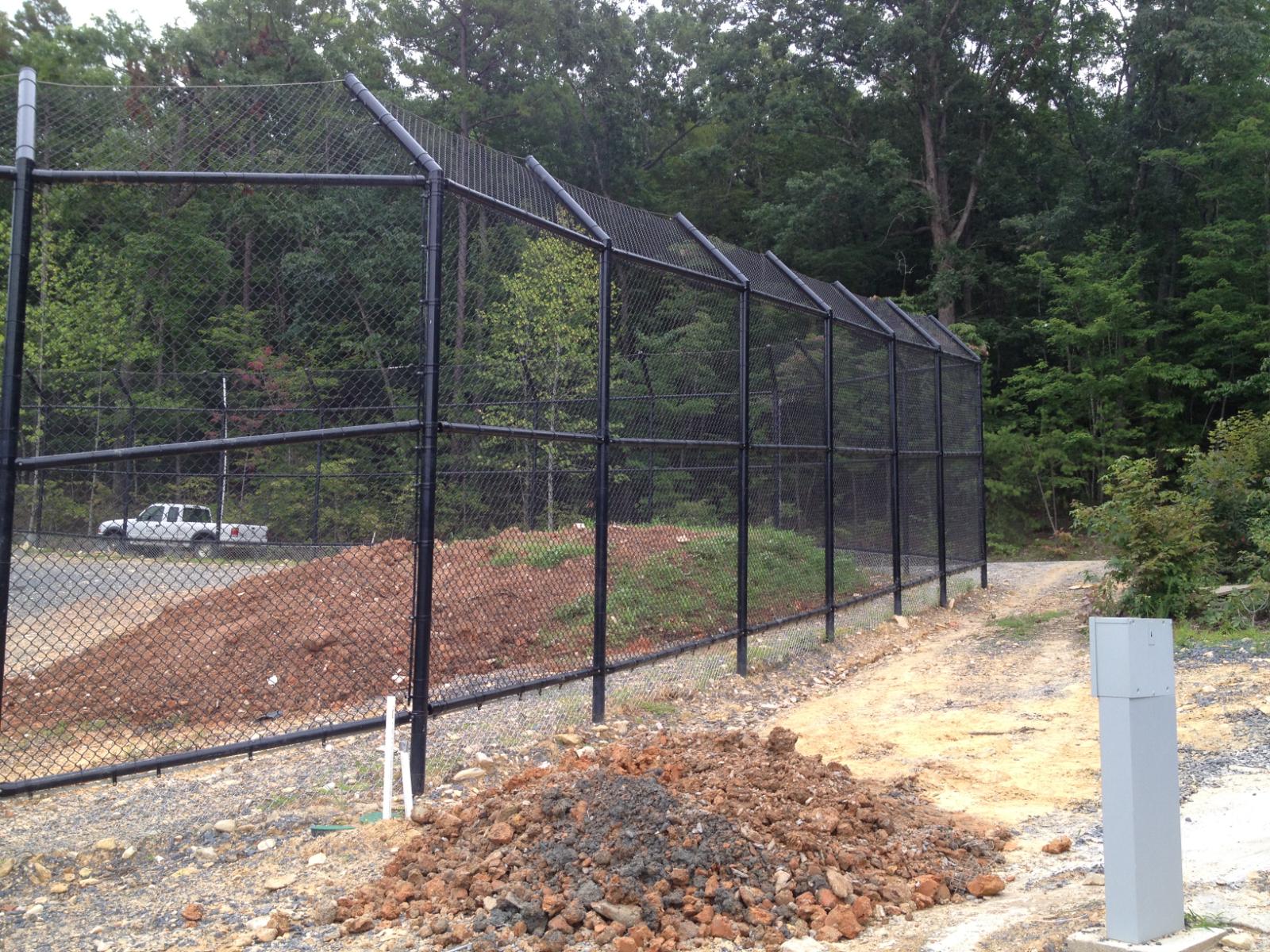 15-foot-high Schedule 80 containment fencing with 4-foot overhang, buried 4 feet out