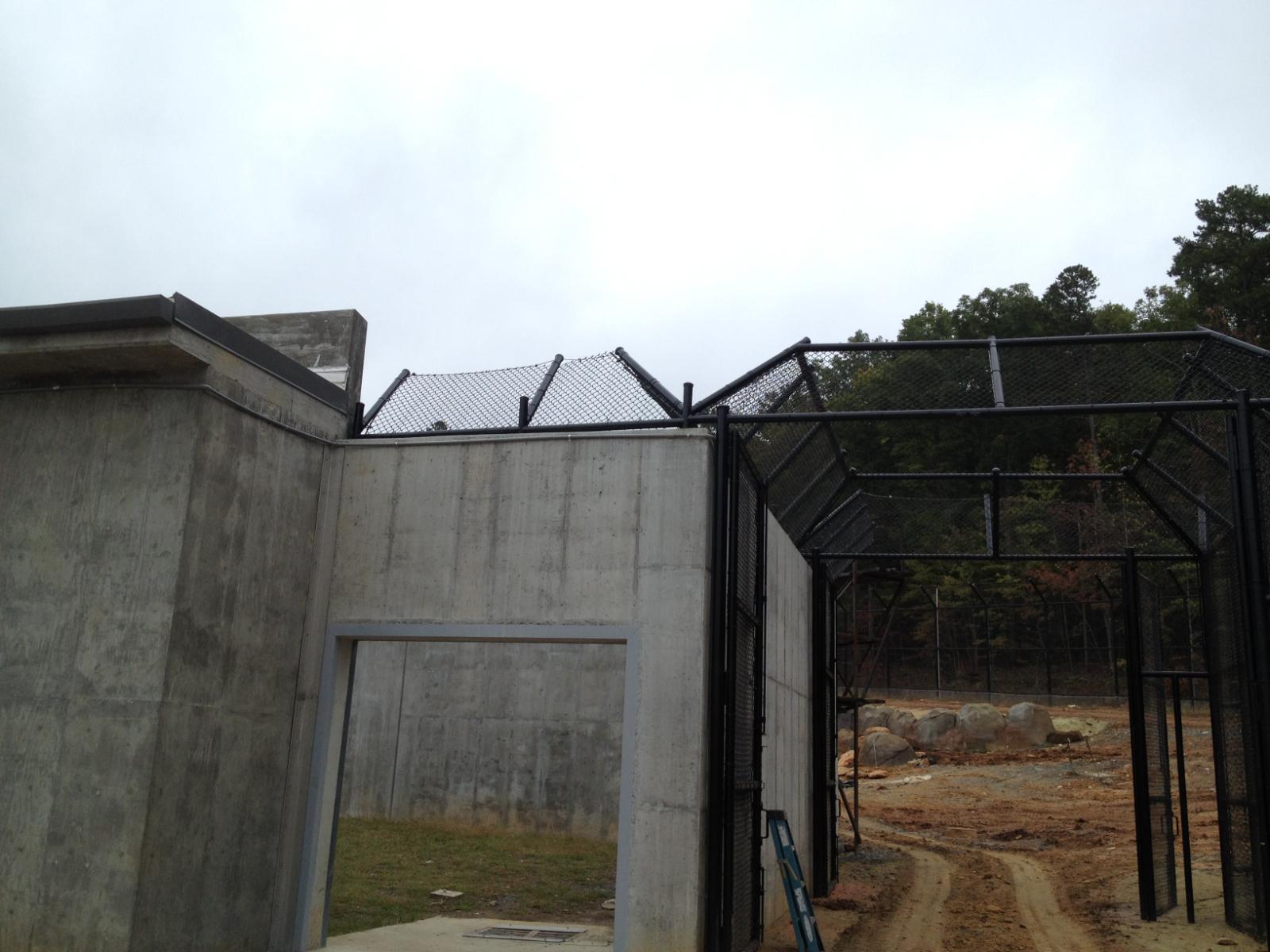 Entrance to polar bear containment area with chain link over concrete walls