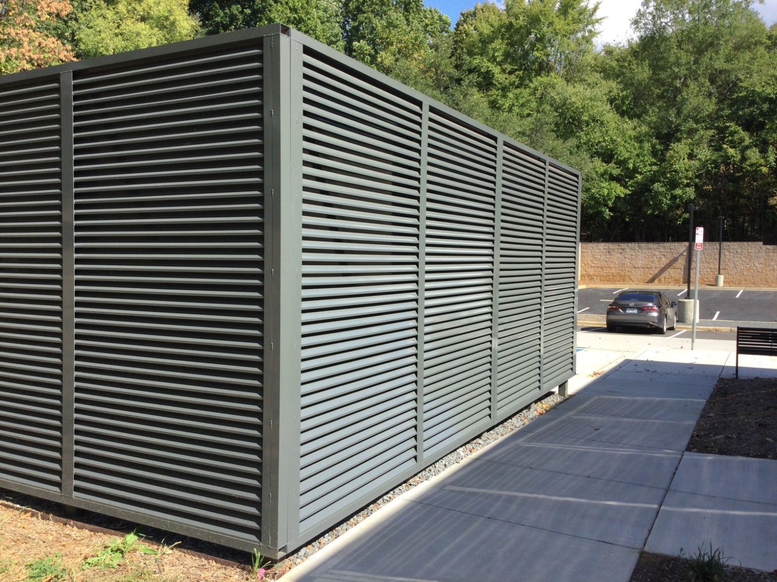 Gray louvered screening panels around chiller at South Library