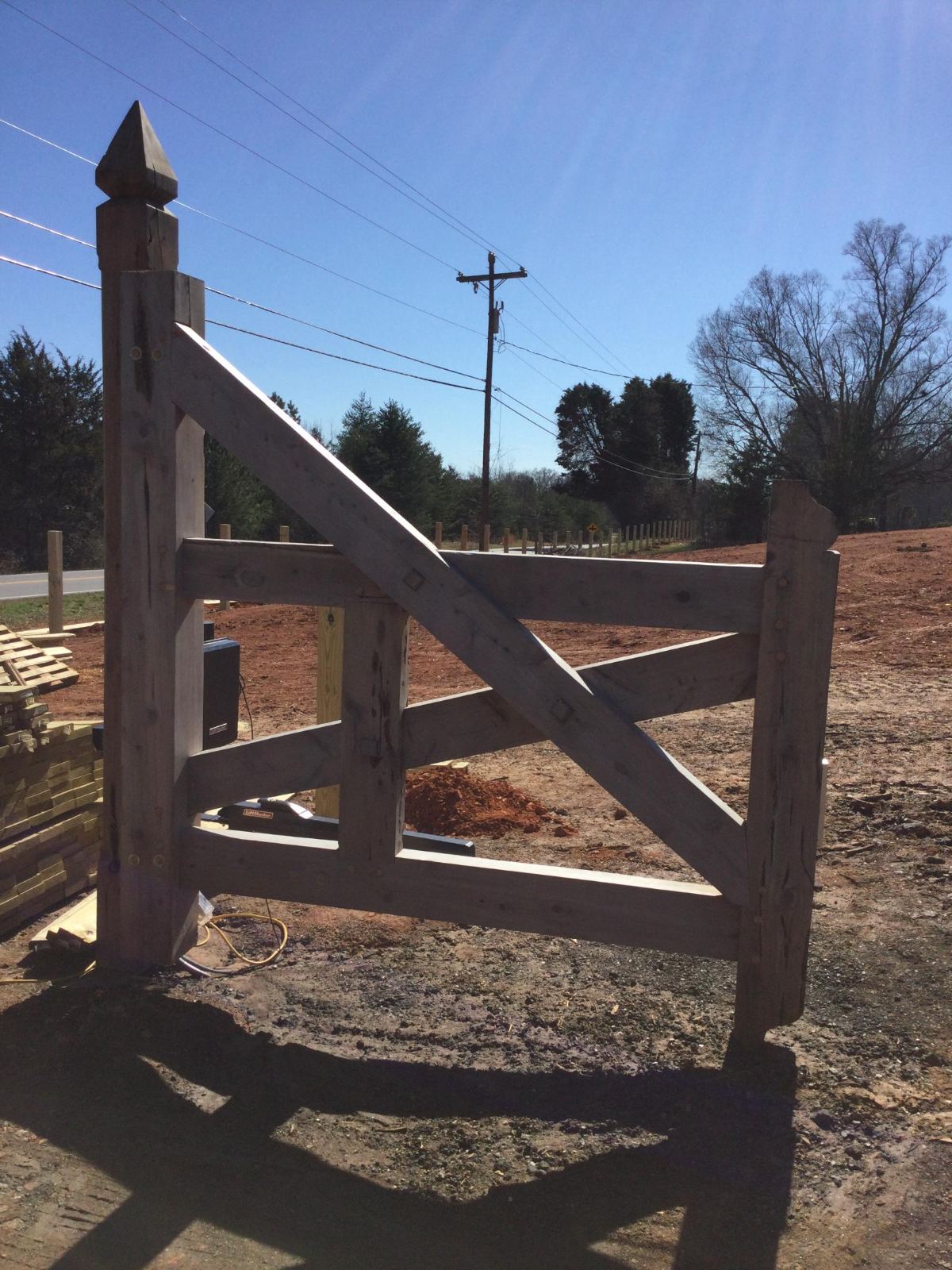 Custom timber gate with carved finial post
