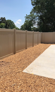 Tan vinyl privacy fence