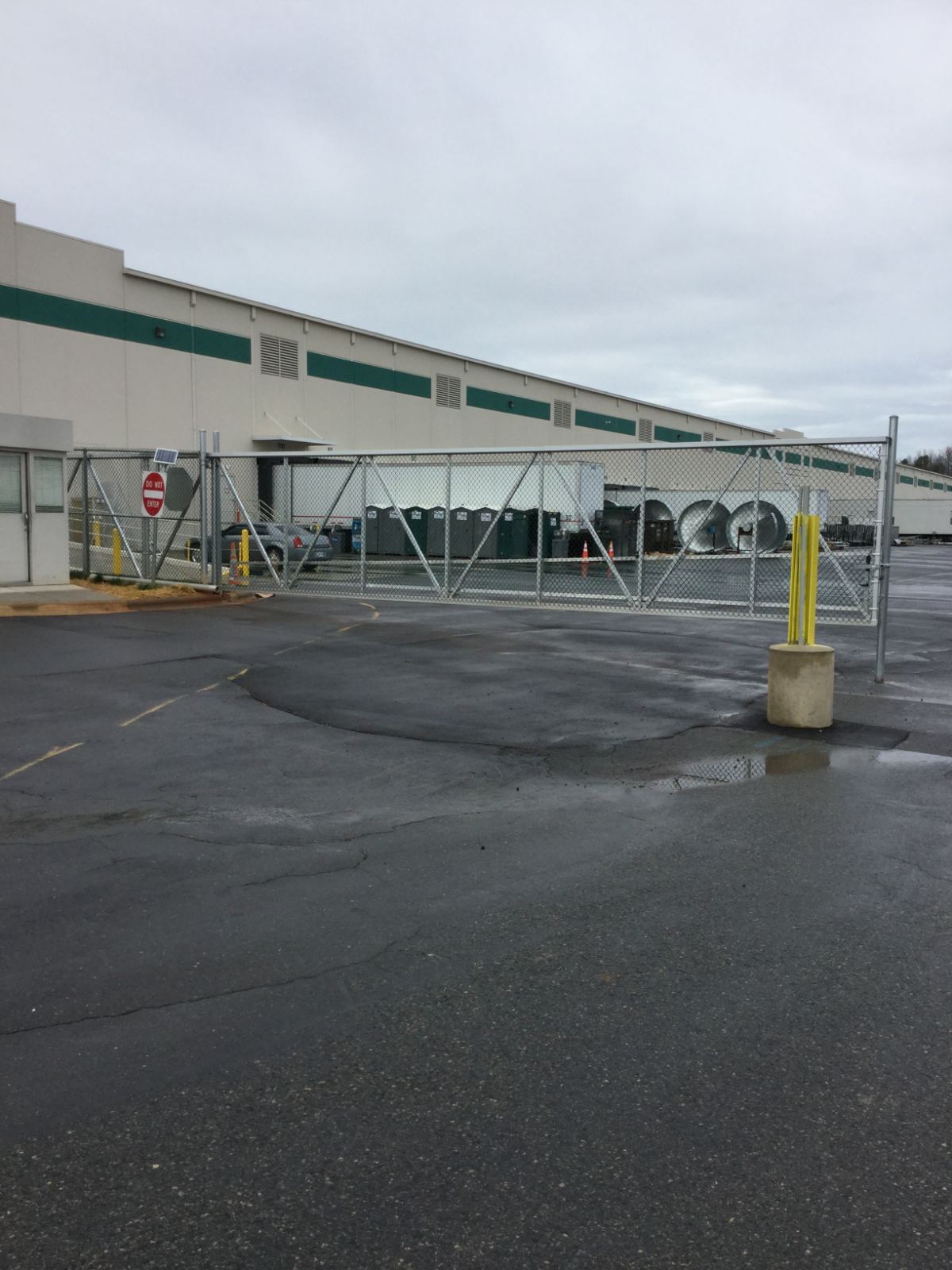 8-foot high aluminum cantilever sliding gate with extra fence panels on the bottom at UPS facility