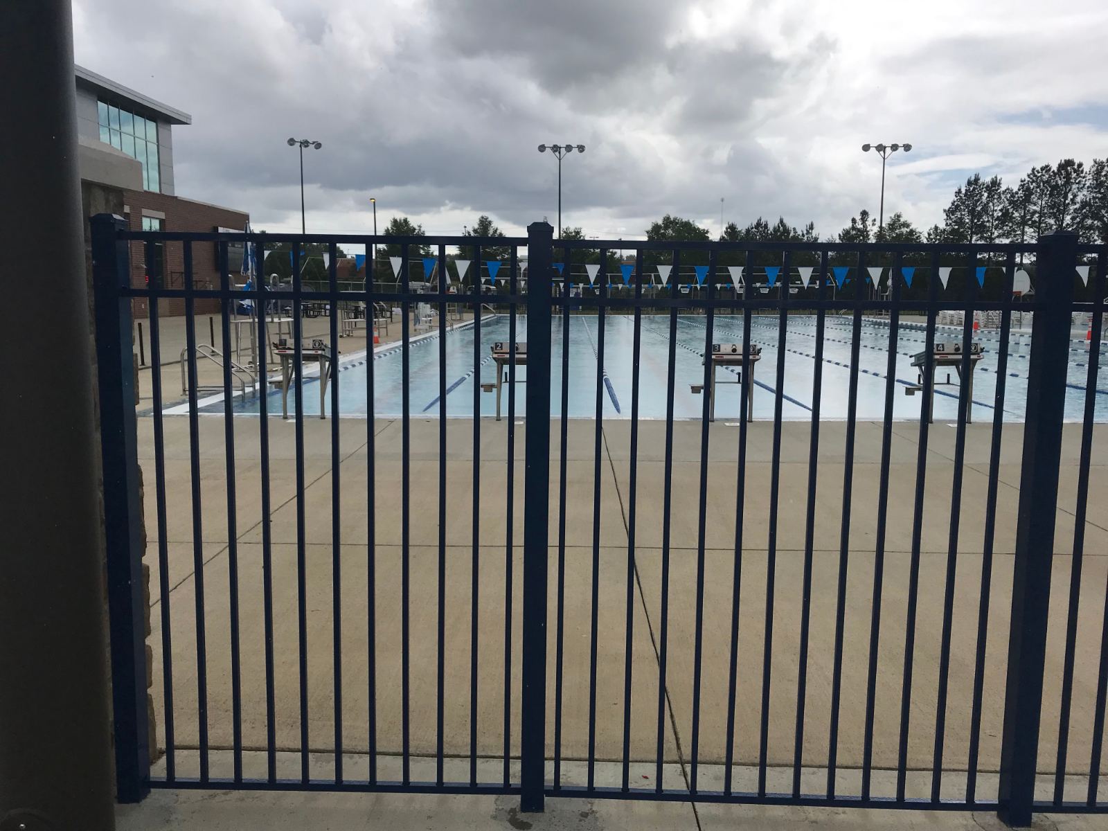 6-foot high blue aluminum fence around outdoor pool deck at YMCA Clover Lake Wylie Aquatics Center